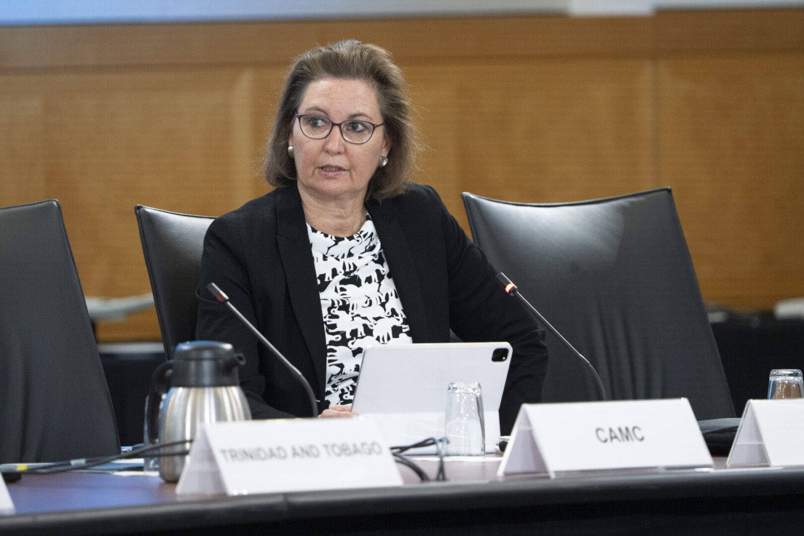 Woman sitting at a conference table.