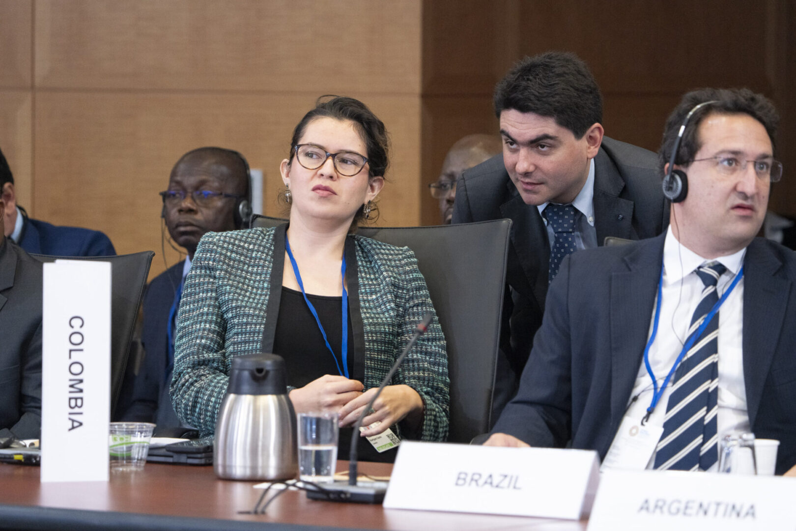 Three people at a conference table.