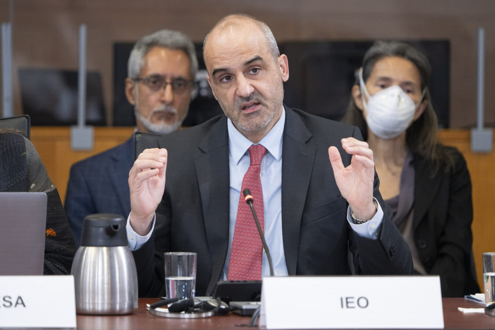 Man in suit speaks at a conference.