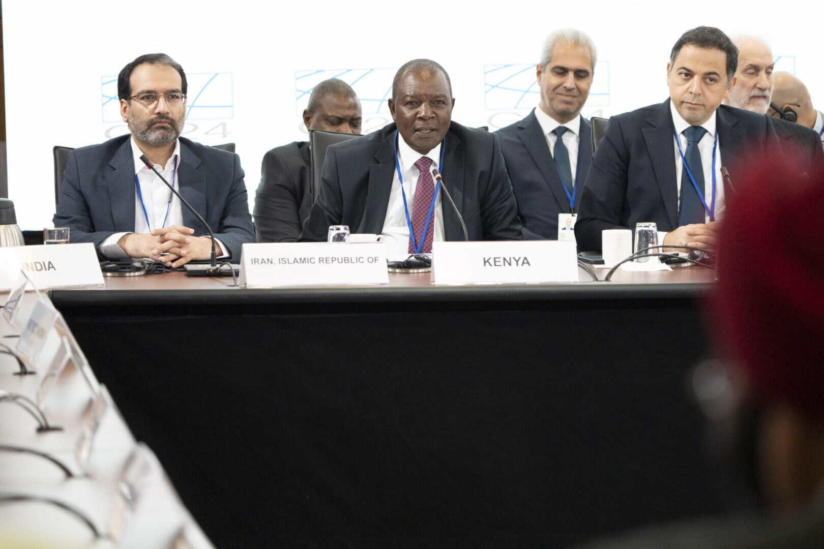 Men in suits at a conference table.