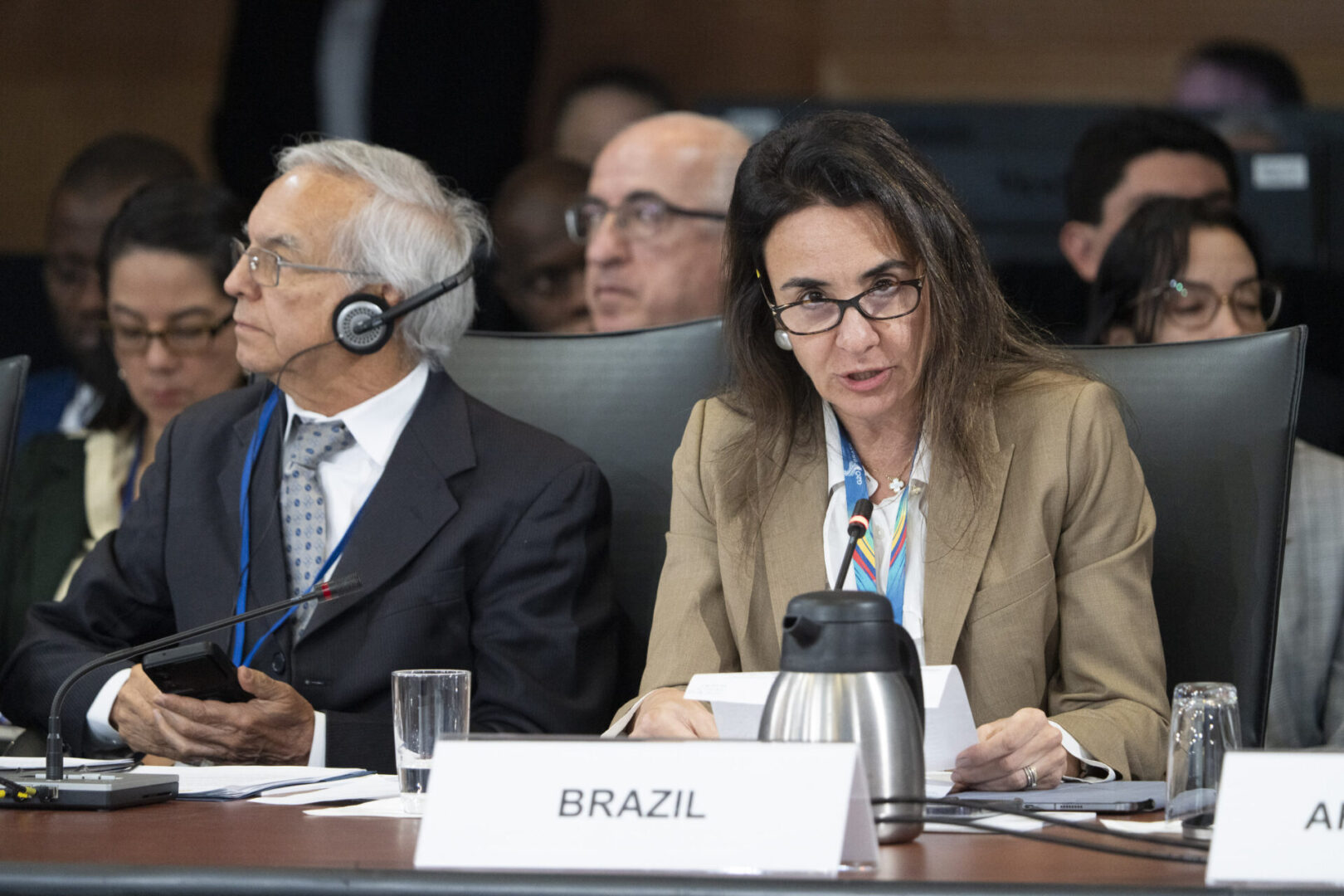 Two people sitting at a table labeled Brazil.